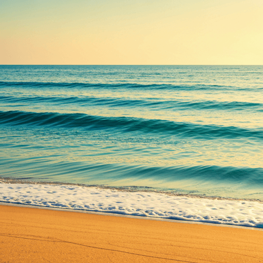 Calm turquoise ocean waves gently rolling onto a sandy beach